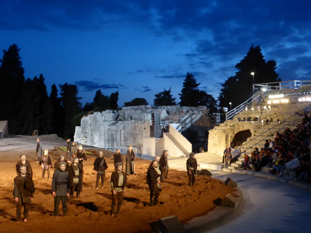 Chorus at the right side of the stage of the Greek Theatre at the Parco Archeologico della Neapolis park, during the play `Agamemnon` by Aeschylus