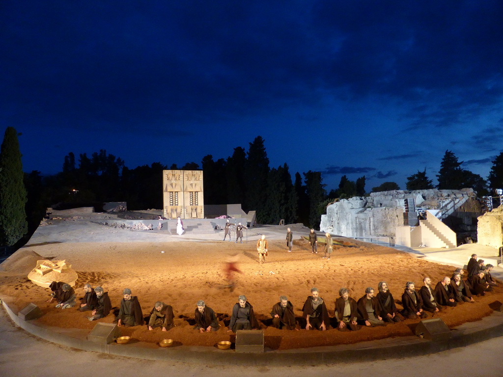 Aegisthus and his soldiers, herald, chorus, Clytemnestra and the corpses of Agamemnon and Cassandra at the gates of Argos at the stage of the Greek Theatre at the Parco Archeologico della Neapolis park, during the play `Agamemnon` by Aeschylus