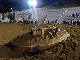 Boat at the stage and grandstand of the Greek Theatre at the Parco Archeologico della Neapolis park, shortly after the play `Agamemnon` by Aeschylus, by night