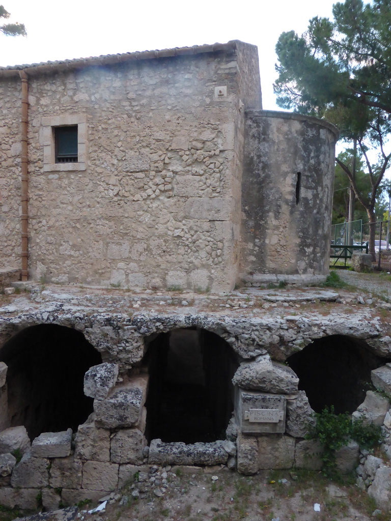 Southeast side of the Chiesa San Nicolò ai Cordari church and the Roman swimming pool at the Parco Archeologico della Neapolis park