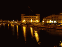 The harbour north of the Ponte Umbertino bridge and the Old Post Office, viewed from the Ponte Umbertino bridge, by night