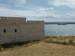 Boat in the Porte Grande harbour and the northwest side of the Castello Maniace castle