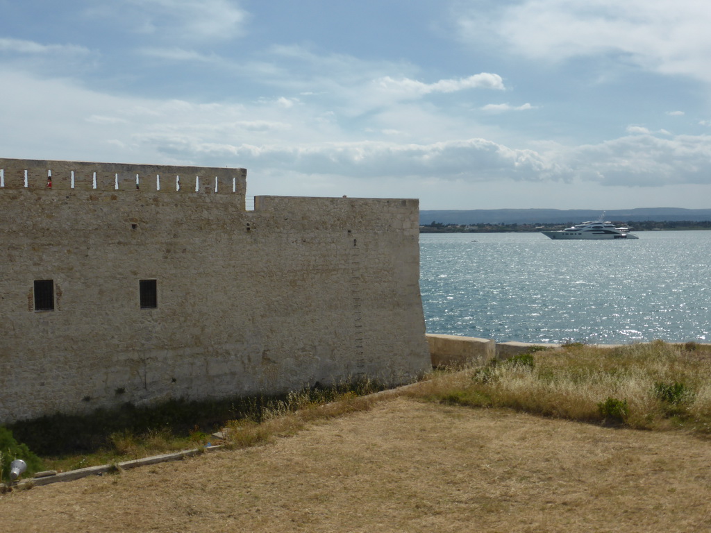 Boat in the Porte Grande harbour and the northwest side of the Castello Maniace castle