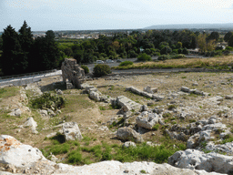 Ruins at the west side of the Greek Theatre at the Parco Archeologico della Neapolis park, viewed from the Nymphaeum