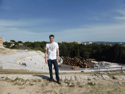 Tim at the Greek Theatre at the Parco Archeologico della Neapolis park, with the stage being prepared for the play `The Wasps` by Aristophanes, the Santuario della Madonna delle Lacrime church and the Porte Grande harbour