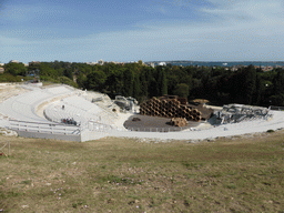 The Greek Theatre at the Parco Archeologico della Neapolis park, with the stage being prepared for the play `The Wasps` by Aristophanes, and the Porte Grande harbour, viewed from the Nymphaeum