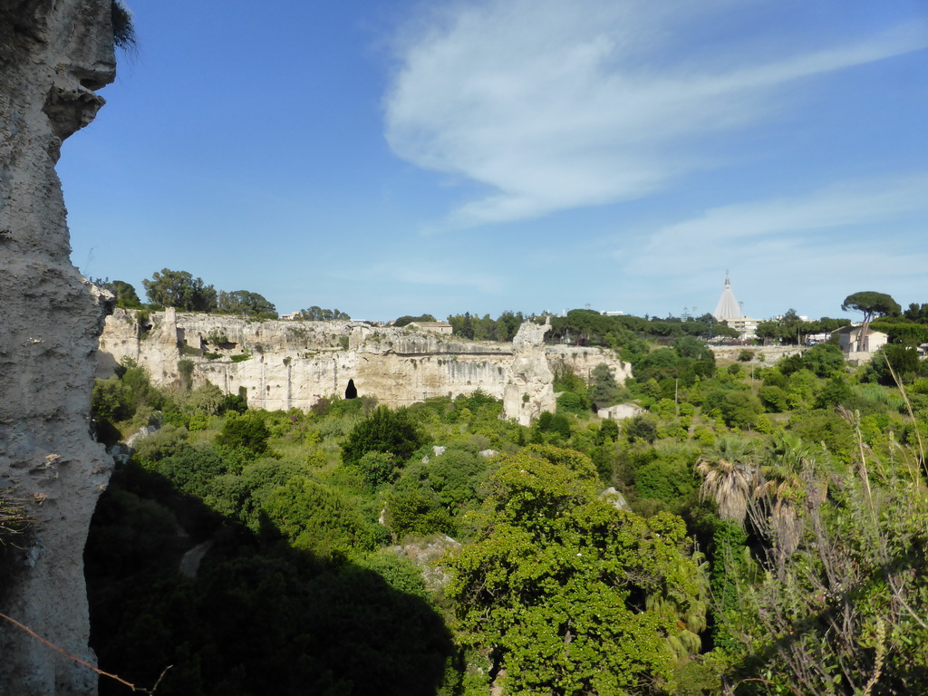 The Latomia del Paradiso quarry at the Parco Archeologico della Neapolis park and the Santuario della Madonna delle Lacrime church, viewed from the back side of the Greek Theatre