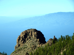 Rock, trees and mountains on the west side of the island, viewed from the rental car on the TF-21 road on the southwest side of the Teide National Park