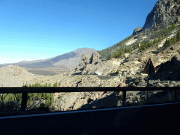 Mount Teide and the TF-21 road, hills, rocks and trees on the southwest side of the Teide National Park, viewed from the rental car