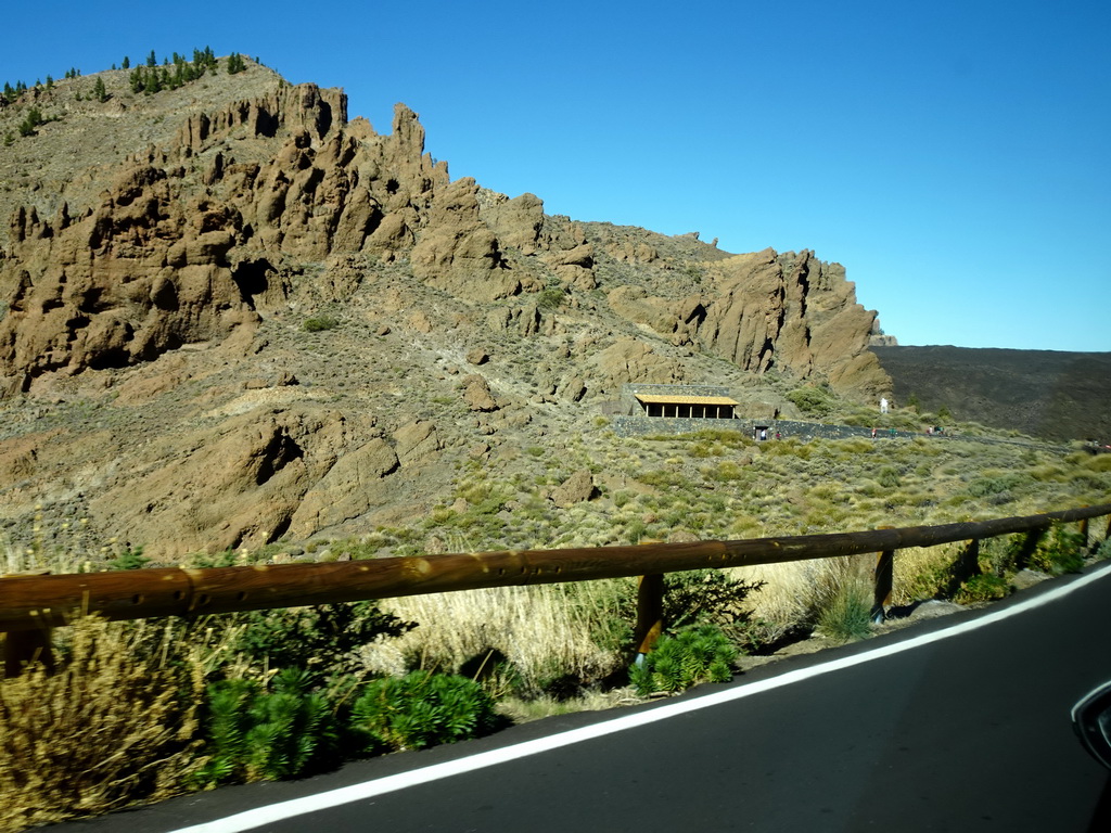 Rocks and the front of the Ethnographic Museum Juan Évora, viewed from the rental car on the TF-21 road on the southwest side of the Teide National Park