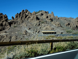 Rocks and the front of the Ethnographic Museum Juan Évora, viewed from the rental car on the TF-21 road on the southwest side of the Teide National Park