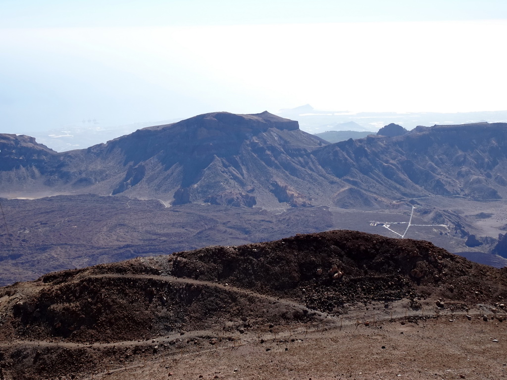 The south side of the Cañadas del Teide crater with the TF-21 road, the Roques de García rocks and the Ermita de las Nieves church, viewed from the La Rambleta viewpoint