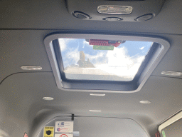 The Roque Nublo rock, viewed through the roof window of the tour bus on the GC-60 road