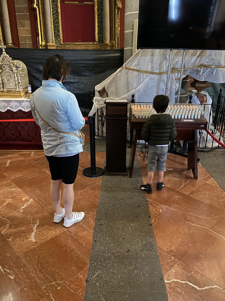 Miaomiao and Max lighting a candle at the Basílica de Nuestra Señora del Pino church