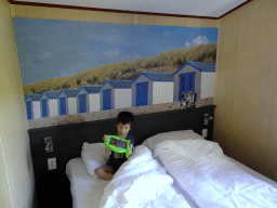 Max playing with iPad in the master bedroom of our holiday home at the Roompot Vakanties Kustpark Texel at De Koog