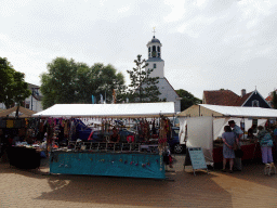 Market stalls and the front of the Hervormde Kerk church at the Dorpsplein square at De Koog