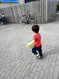 Max with a ball in front of Swimming Paradise Calluna at the Roompot Vakanties Kustpark Texel at De Koog