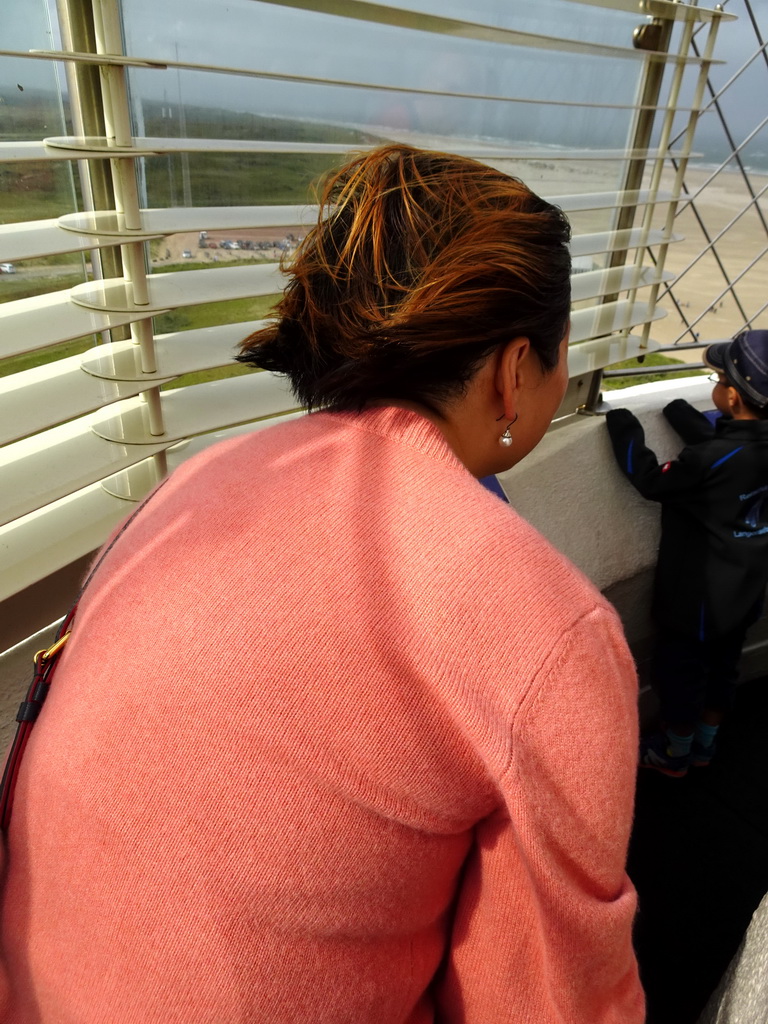 Miaomiao at the viewpoint at the top floor of the Lighthouse Texel at De Cocksdorp, with a view on the beach and dunes