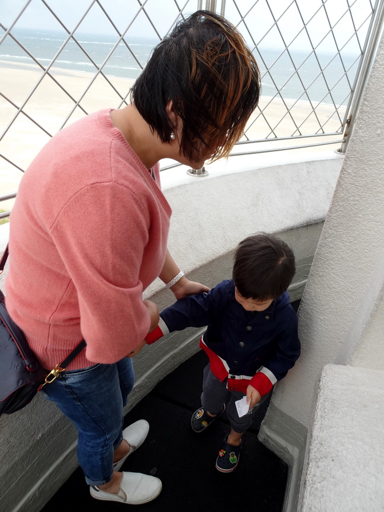 Miaomiao and Max at the viewpoint at the top floor of the Lighthouse Texel at De Cocksdorp, with a view on the beach