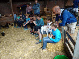 People cuddling animals at the Texel Sheep Farm at Den Burg