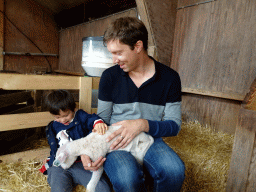 Tim and Max cuddling a lamb at the Texel Sheep Farm at Den Burg