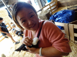 Miaomiao cuddling a chicken at the Texel Sheep Farm at Den Burg