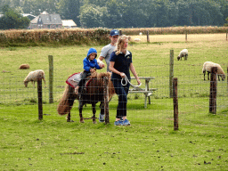 People riding a pony at the Texel Sheep Farm at Den Burg
