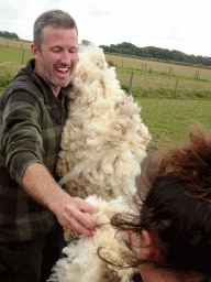 Shephard giving wool to people at the Texel Sheep Farm at Den Burg