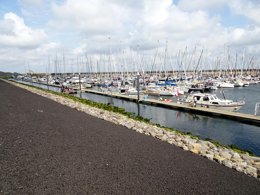 People catching crabs and boats in the Waddenhaven harbour at Oudeschild