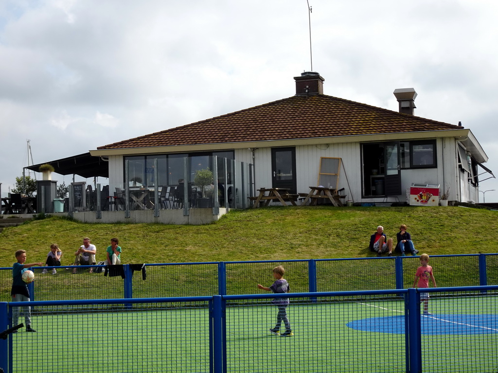 The Compagnie restaurant and a playground at the Waddenhaven harbour at Oudeschild