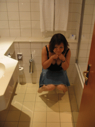 Miaomiao on the toilet of our room at the Dorint Novotel hotel