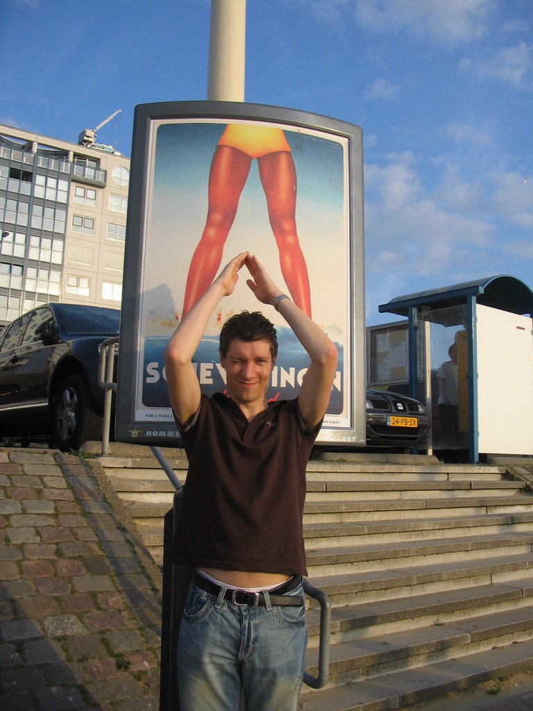 Tim with a billboard at the Strandweg street of Scheveningen