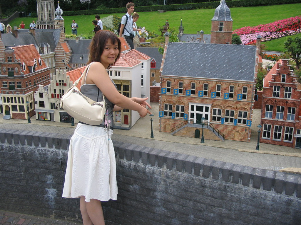 Miaomiao with scale models of Museum Martena of Franeker and other buildings at the Madurodam miniature park