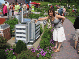 Miaomiao with a scale model of the Randstad building of The Hague at the Madurodam miniature park