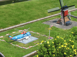 Miaomiao with scale models of a helicopter and a Windmills of Kinderdijk at the Madurodam miniature park