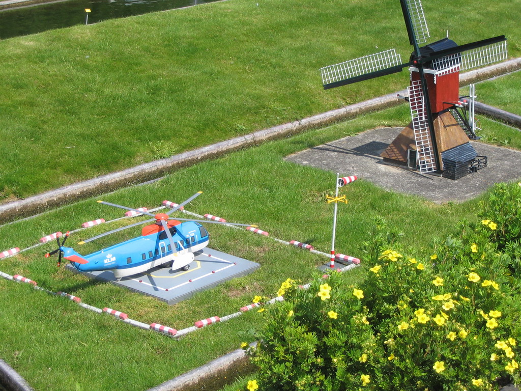 Miaomiao with scale models of a helicopter and a Windmills of Kinderdijk at the Madurodam miniature park