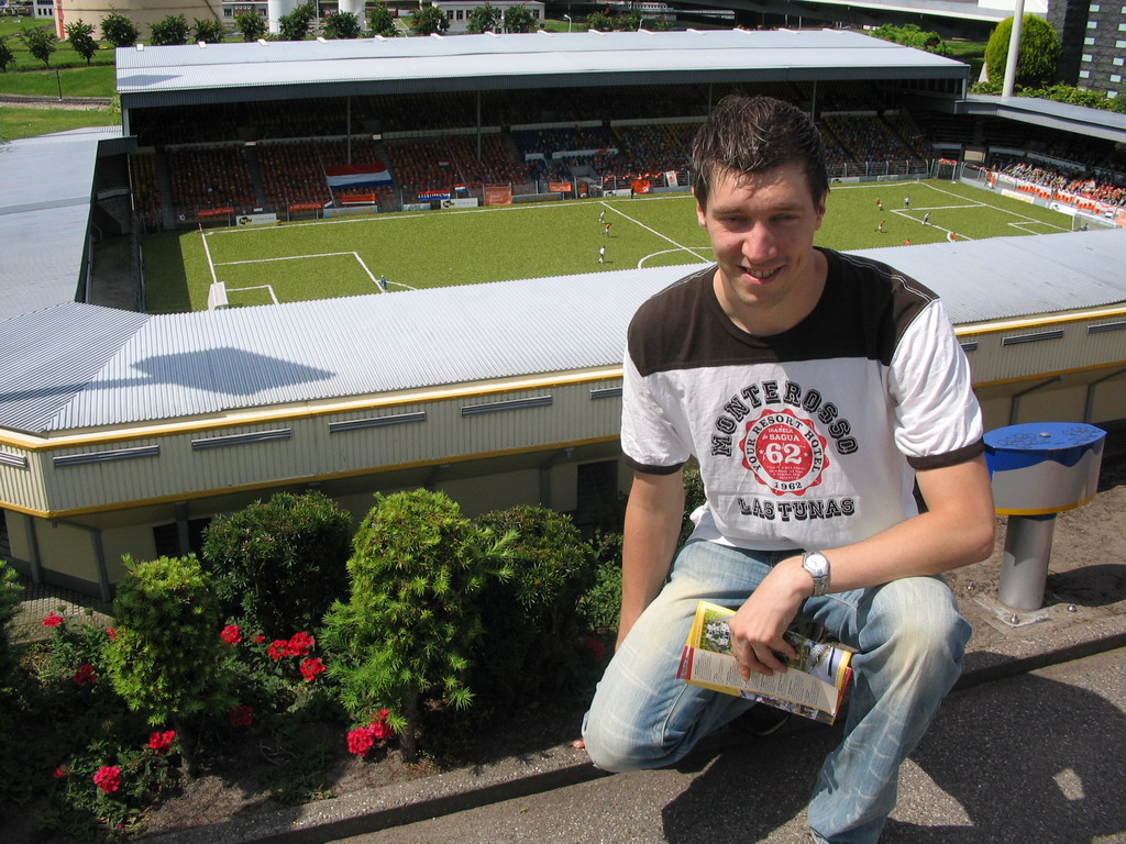 Tim with a scale model of a soccer stadium at the Madurodam miniature park