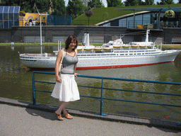 Miaomiao with a scale model of the ship `Rotterdam` at the Madurodam miniature park