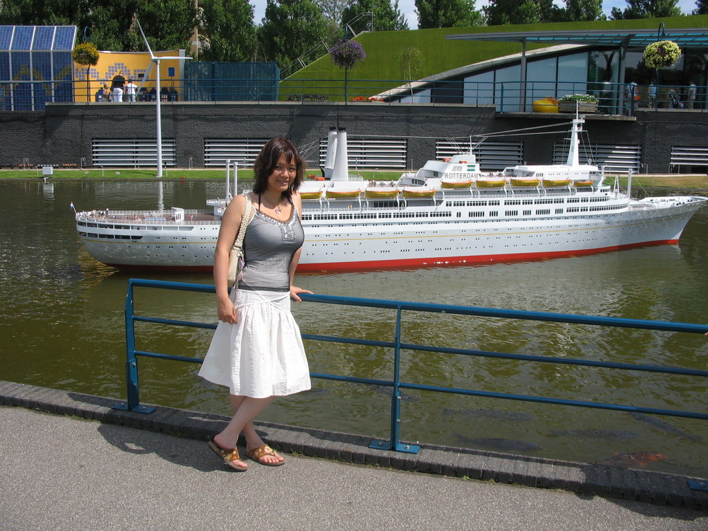 Miaomiao with a scale model of the ship `Rotterdam` at the Madurodam miniature park