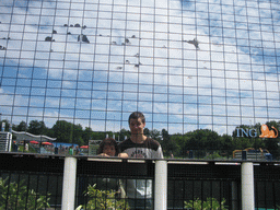 Tim and Miaomiao reflected in a scale model of an ING Bank at the Madurodam miniature park