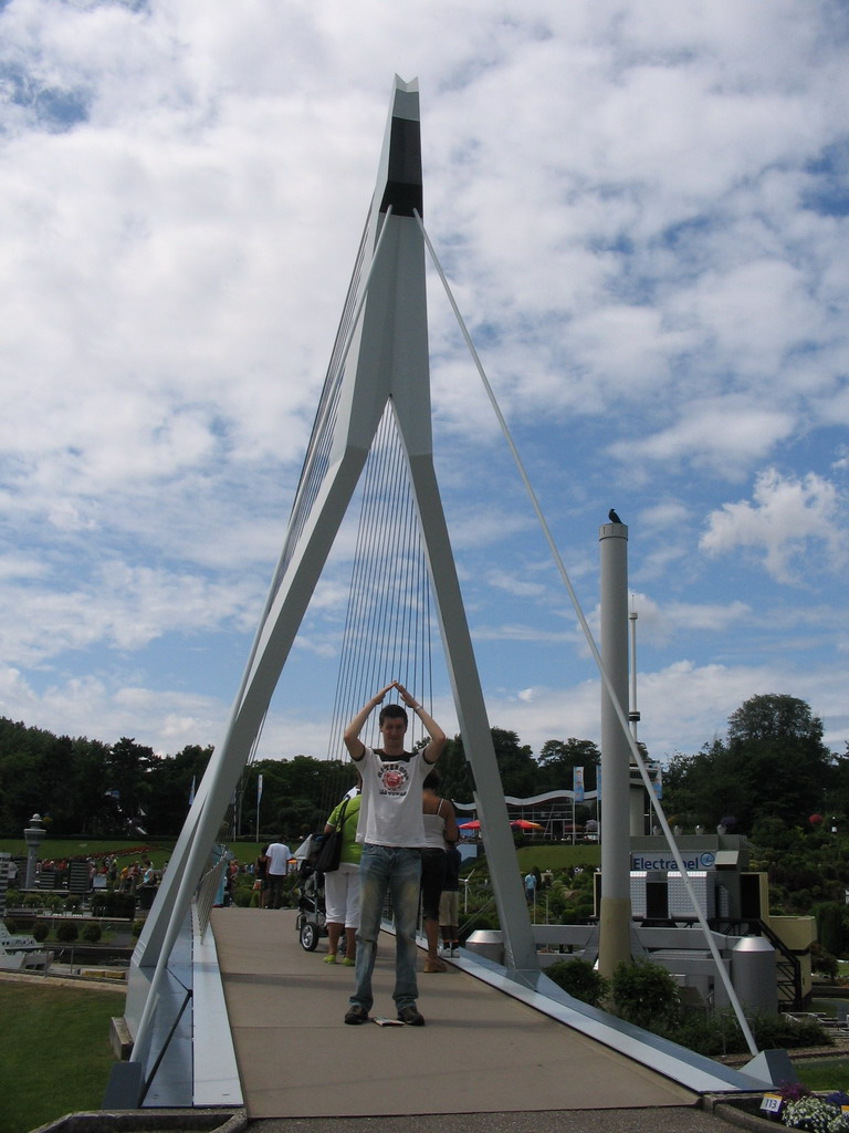 Tim on a scale model of the Erasmusbrug bridge of Rotterdam at the Madurodam miniature park