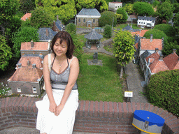 Miaomiao with scale models of a kiosk and other buildings at the Madurodam miniature park