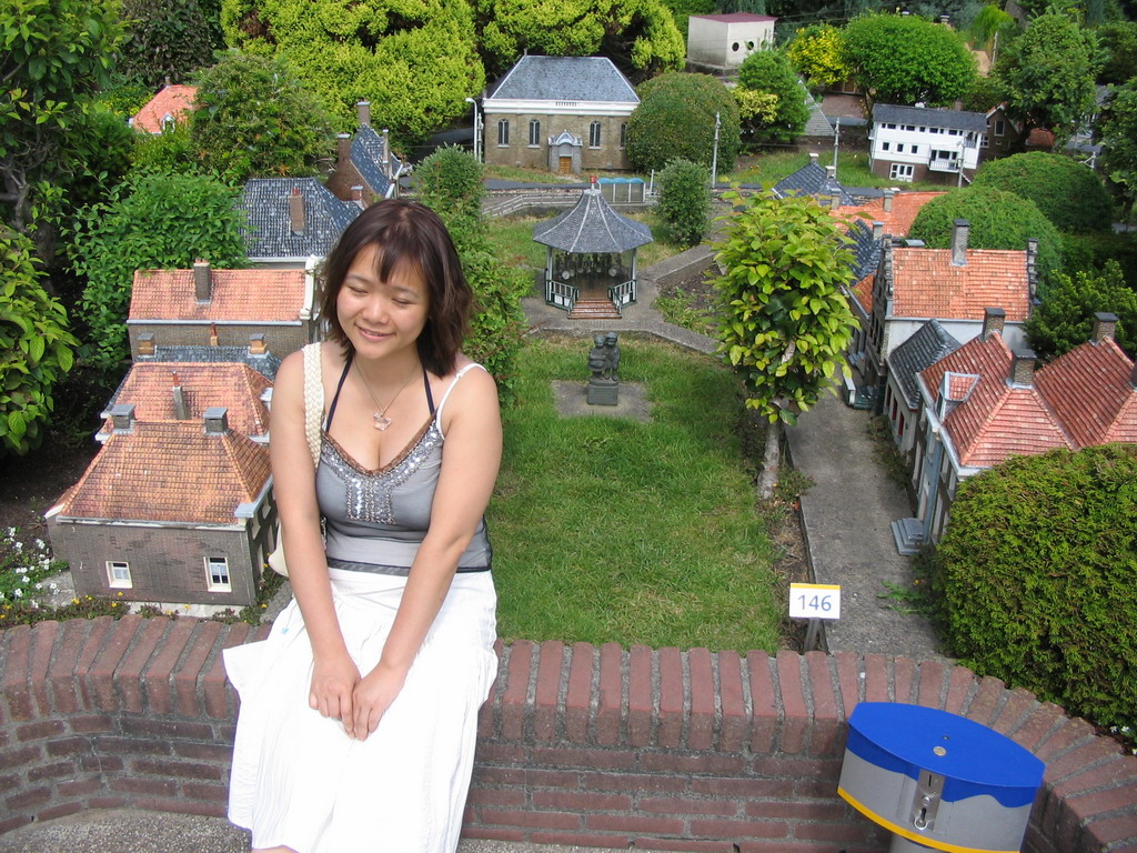 Miaomiao with scale models of a kiosk and other buildings at the Madurodam miniature park