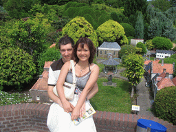 Tim and Miaomiao with scale models of a kiosk and other buildings at the Madurodam miniature park