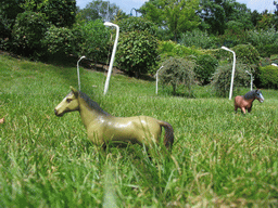 Scale models of horses in a grassland at the Madurodam miniature park