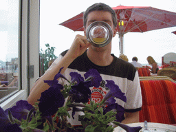 Tim with a beer at a beach pavilion at the Strandweg street of Scheveningen