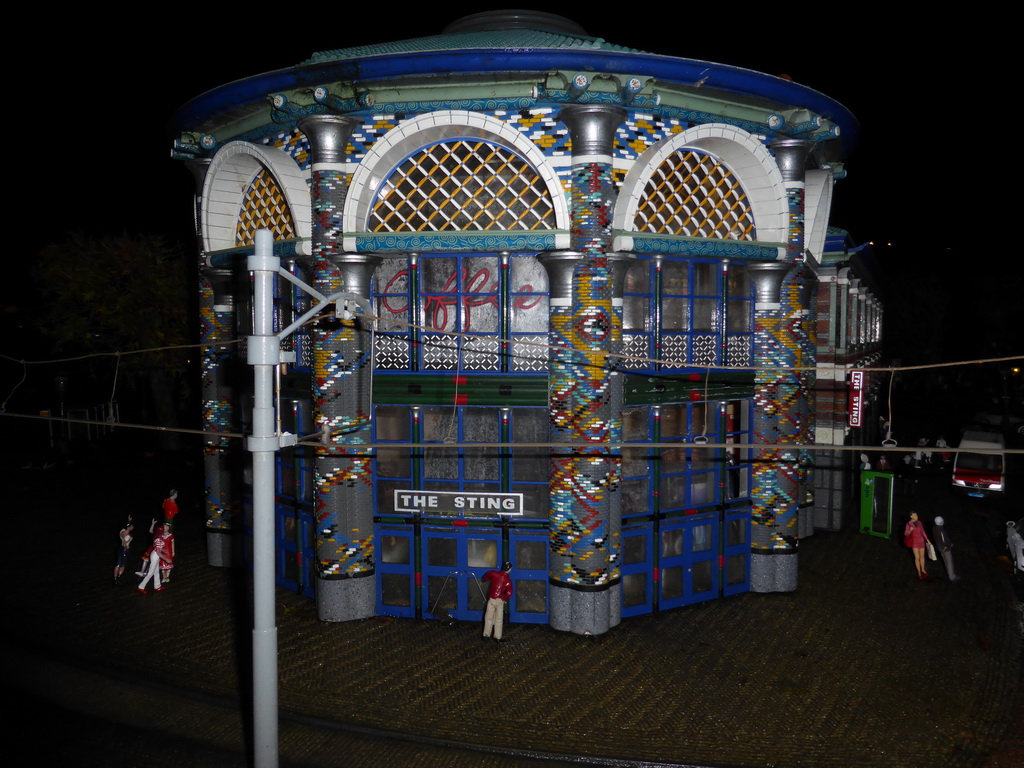 Scale model of The Sting Coffée building at the Dagelijkse Groenmarkt square of The Hague at the Madurodam miniature park, by night