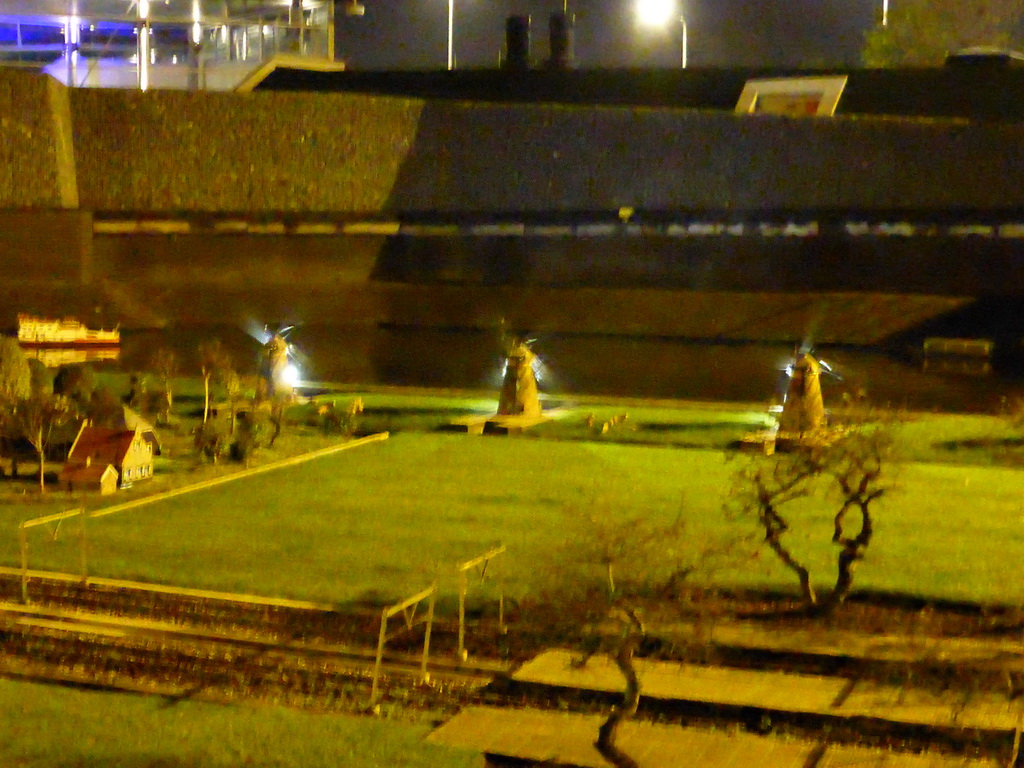Scale models of windmills and a railroad at the Madurodam miniature park, by night