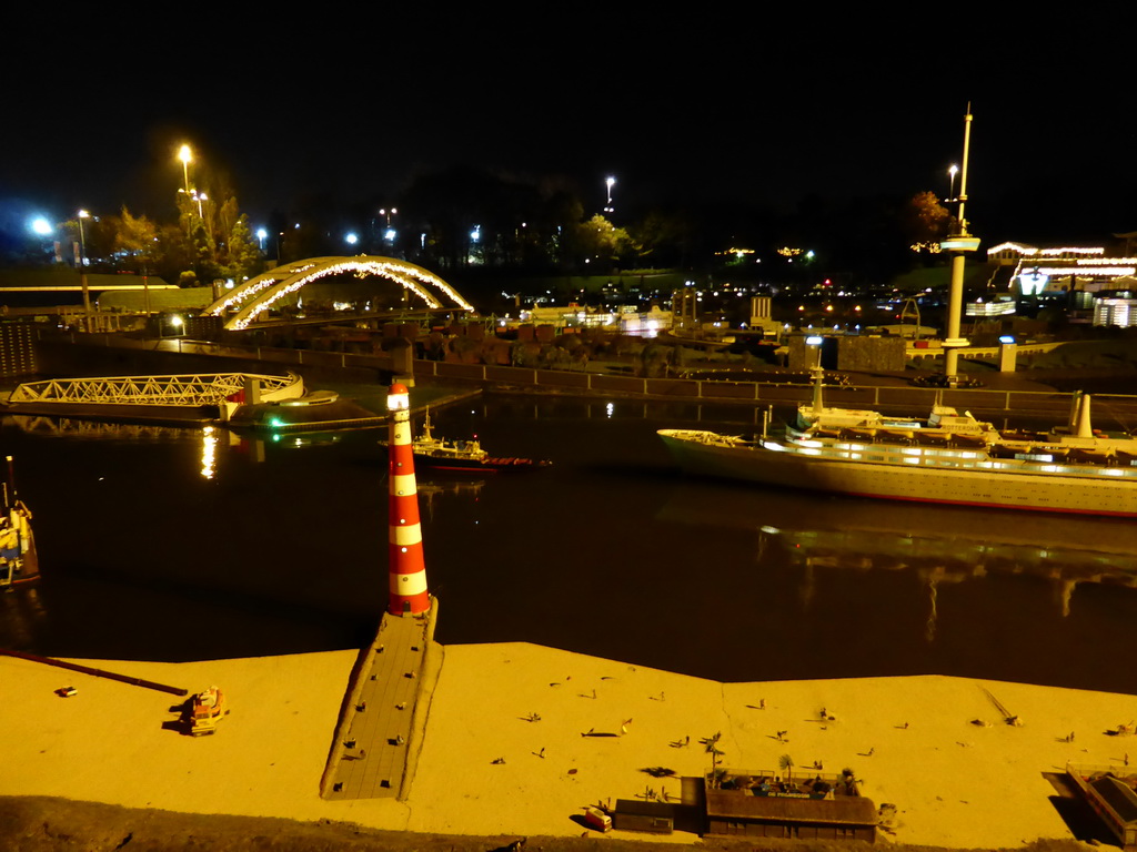 Scale model of the lighttower of Ameland and the Rotterdam harbour with the Van Brienenoordbrug bridge and the Euromast tower at the Madurodam miniature park, by night