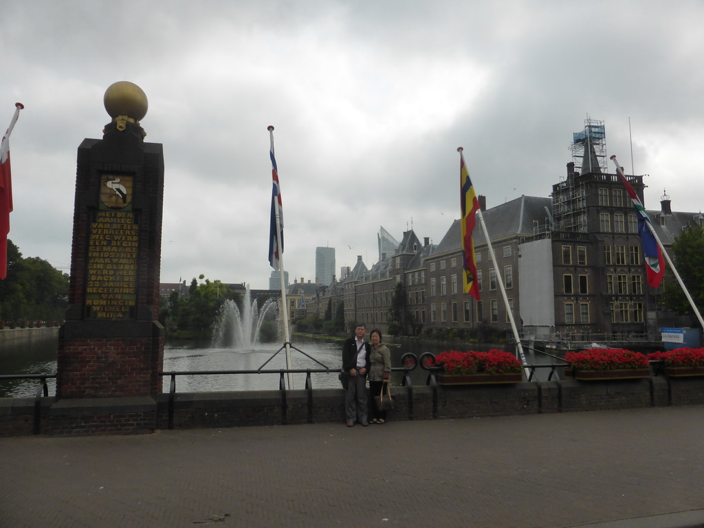 Miaomiao`s parents with the Dutch province flags at the Buitenhof square, the Hofvijver pond and the Binnenhof buildings